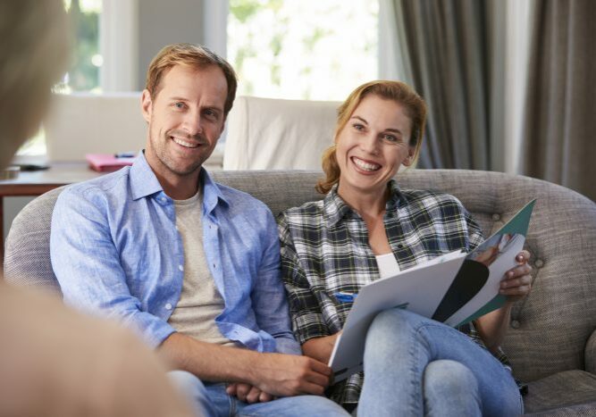 Happy young couple taking financial advice at home Happy young couple taking financial advice at home
